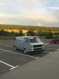 an old van is parked in a parking lot