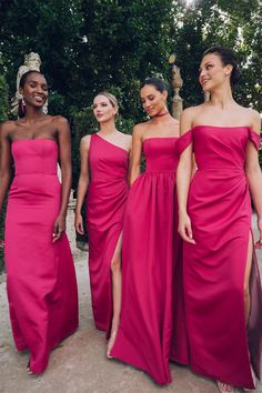 three women in pink dresses standing next to each other