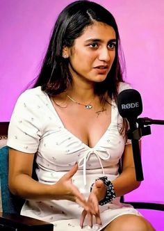 a woman sitting in a chair with a microphone