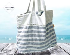 This huge striped linen bag will fit all your necessary beach belongings and there will still be enough space for shopping. White and light blue stripes give marine ambience to your leisure. It is very lightweight and capacious, with a big inner pocket convenient for quick access to your necessary belongings. The handles comfortably fit your shoulders. The handles colors and pocket design may vary. Please, get in touch before purchasing to chose exact option. Dimensions: 20,9x16,9 in / 53x43 cm Striped Beach Bag For Everyday Summer Use, Summer Beach Bag With Striped Lining, Striped Beach Bag For Travel, Striped Summer Beach Bag, Striped Tote Beach Bag, Striped Summer Beach Bag For Beach Season, Summer Striped Beach Bag For Beach Season, Striped Summer Style Bag, Striped Summer Beach Bag For Vacation