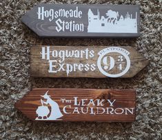 three wooden signs that say hogwarts express and the leaky cauldron