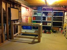 an unfinished room with shelves and ladders in it