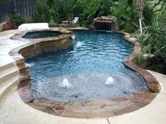 an outdoor pool with water features and landscaping