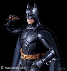 the batman action figure is posed with his hands in one hand and an arm out