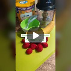 bananas, strawberries, and yogurt are on a cutting board next to a blender