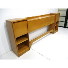 a wooden shelf with two open shelves next to each other