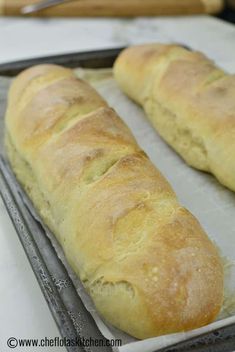 two loaves of bread sitting on top of a pan