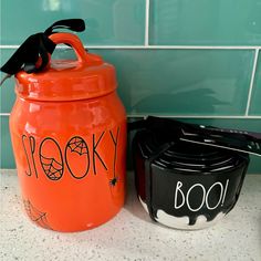 two halloween jars sitting next to each other