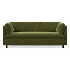 a green couch sitting on top of a white floor