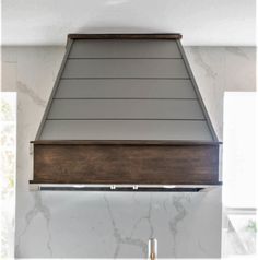 a kitchen with a stove top oven and white counter tops on the wall behind it