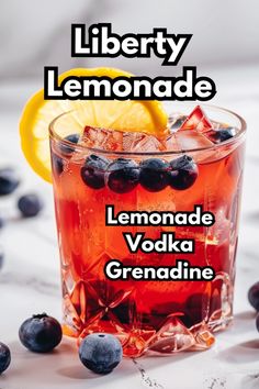 a glass filled with lemonade and blueberries