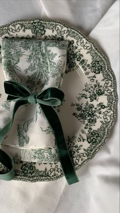 a green and white plate with a bow on it