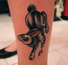 a tattoo on the leg of a person with a rabbit in it's head