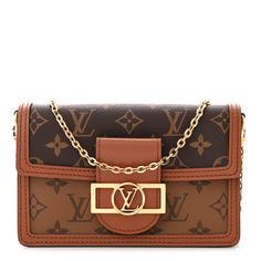 This is an authentic LOUIS VUITTON Reverse Monogram Dauphine Chain Wallet. This stylish shoulder bag is crafted of Louis Vuitton monogram on toile canvas. The bag features an optional gold chain shoulder strap and a facing flap with toffee leather trim and a decorative brass Louis Vuitton logo clasp. This opens to a black microfiber interior with zipper and patch pockets. Luxury Travel Wallet On Chain With Branded Hardware, Luxury Wallet On Chain With Branded Hardware For Travel, Luxury Monogram Rectangular Shoulder Bag, Gold Monogram Canvas Shoulder Bag With Chain Strap, Rectangular Monogram Canvas Shoulder Bag, Brown Monogram Canvas Bag With Chain Strap, Luxury Brown Wallet On Chain Crossbody, Luxury Brown Crossbody Wallet On Chain, Designer Brown Wallet On Chain With Chain Strap