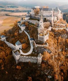 an aerial view of a castle on top of a hill