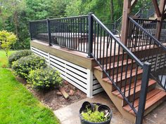 a deck with railing and planters on it