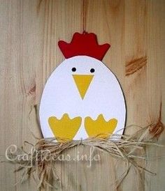 a paper cut out of a chicken on a wooden surface