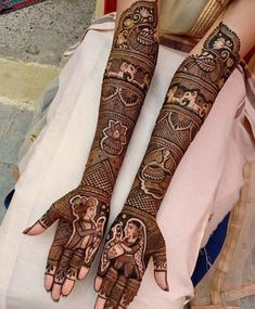 two hands with henna designs on them