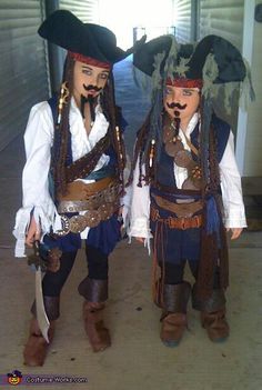 two men dressed in pirate costumes standing next to each other