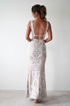 the back of a woman wearing a white dress