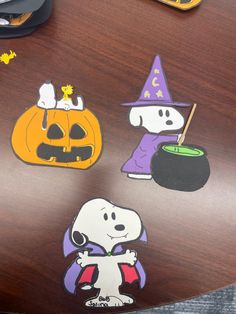 a wooden table topped with lots of stickers on it's surface, including a jack - o - lantern