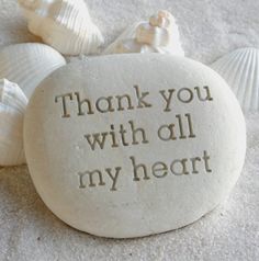 a rock that says thank you with all my heart surrounded by sea shells and seashells