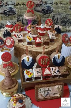 a table topped with lots of cupcakes and cakes