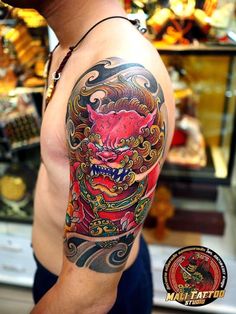 a man with a dragon tattoo on his arm