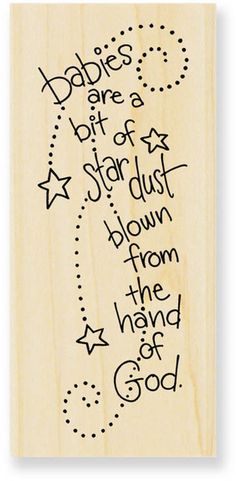 a wooden stamp with the words babies are a bit of star dust down from the hand of god