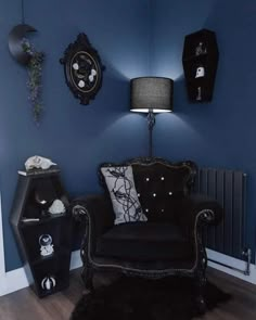 a living room with blue walls and black furniture