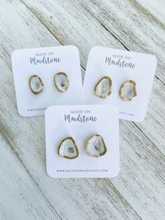 three pairs of earrings with the words made for madison written on them in gold foil