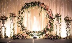 a wedding stage decorated with flowers and candles