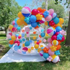 an inflatable bubble filled with colorful balloons