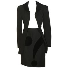 Moschino Cheap and Chic vintage 1990s black suit with velvet accents. Jacket features velvet collar and pockets, while skirt features a question mark that wraps around the skirt. Velvet loop at bottom of collar, possibly for holding a scarf. Jacket fastens with buttons and snap, skirt has back zip and button closure. 100% virgin wool. Fully lined in 60% acetate, 40% rayon. Labelled size IT 44, but runs very small. Best fits an XS, see measurements. Jacket bust (at underarm) 34". Jacket waist 27" Black Question Mark, A Question Mark, Costume Noir, Chanel Suit, Scarf Jacket, Moschino Couture, Velvet Collar, Velvet Accents, Moschino Cheap And Chic