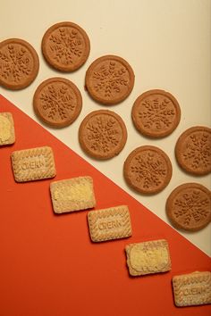 several cookies are arranged in the shape of an arrow on a red and white background