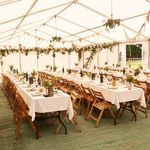 tables and chairs are set up in a large tent