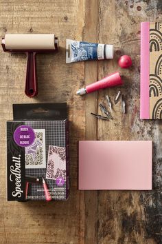 some crafting supplies are laying out on a wooden table with paper, scissors and glue