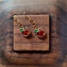 Adorable Dangly Earrings | Handmade Boho Jewelry | Lightweight Earrings Add some juicy shine with these vibrant gorgeous dangly earrings! Handcrafted with love, these earrings are designed to make a statement while remaining lightweight and comfortable for all-day wear.  ✨ Features: Beautifully simple design: Golden apple with shiny red jewel that sparkles and green enamel leaf Lightweight and comfortable: Perfect for everyday wear or special occasions. Versatile style: Dress them up or down for Earrings Handmade Boho, Handmade Boho Jewelry, Red Jewel, Golden Apple, Lightweight Earrings, Dangly Earrings, Etsy Earrings Dangle, Handmade Boho, Light Weight Earrings