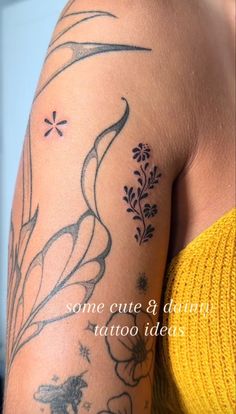 the back of a woman's arm with tattoos on it