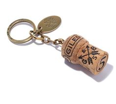 a wine cork keychain with a bottle opener attached to it's side