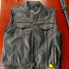 Brand New Never Worn Never Tried On New With Tags Street & Steel Brand Concealed Carry Pockets On Both Sides, Black Leather Biker Vest. Redwood/Cali Style Model, Pretty Closely Resembles What Jax From Sons Of Anarchy Wore The Entire Series. With The Short Collar And Buttons And Zippers. Msrp Is $170 #Soa #Biker #Bikervest #Leather #Ridingvest #Moto #Motorcycles Black Biker Jacket With Snap Buttons, Leather Vest For Motorcycling In Fall, Leather Vest For Motorcycling, Fall Season, Fitted Leather Jacket With Pockets For Biker Events, Fitted Biker Jacket With Snap Buttons, Fitted Moto Biker Jacket With Pockets, Black Fitted Moto Vest, Fitted Biker Outerwear With Snap Buttons, Fitted Biker Vest For Fall