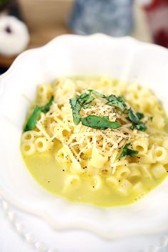 a white bowl filled with pasta and sauce