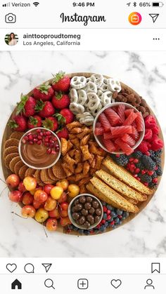 a platter filled with fruit and snacks