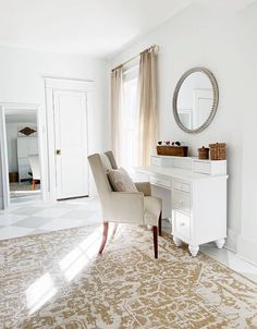 a chair sitting in front of a mirror on top of a dresser next to a window