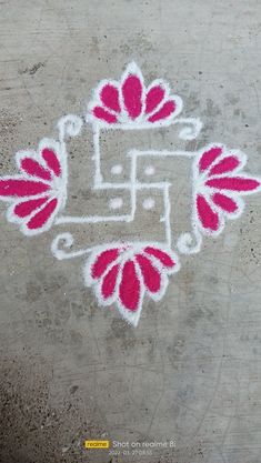 an artistic drawing on the ground with pink flowers