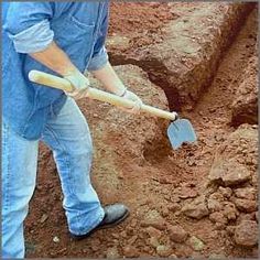 a man digging dirt with a shovel