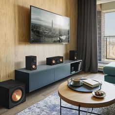 a living room with speakers and a large window