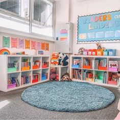 a child's playroom with bookshelves, toys and stuffed animals on the floor