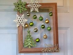 a wooden frame with christmas ornaments hanging from it