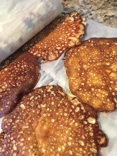 four pancakes sitting on top of a piece of paper